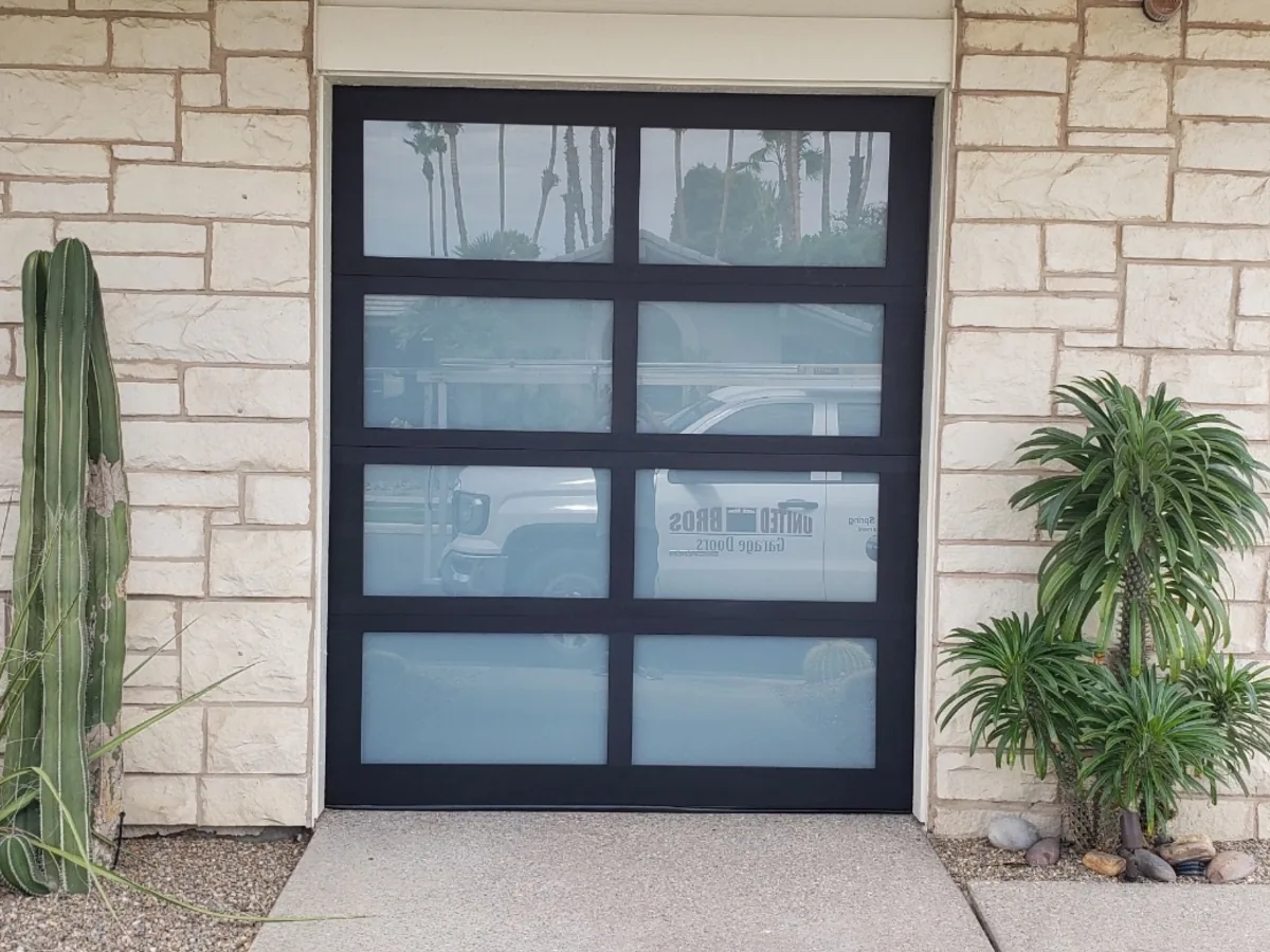 Frosted glass garage door with a black aluminum frame