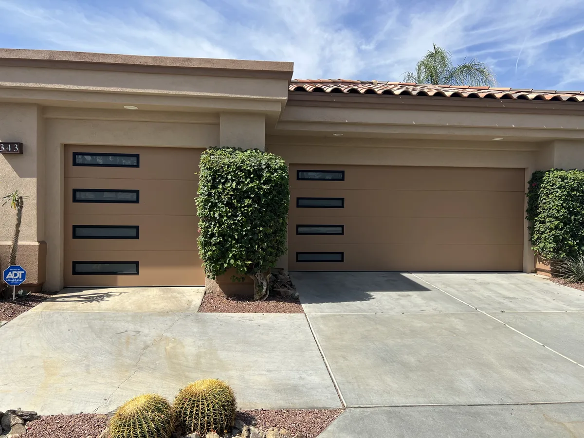 Two dark modern garage doors with vertical window slots