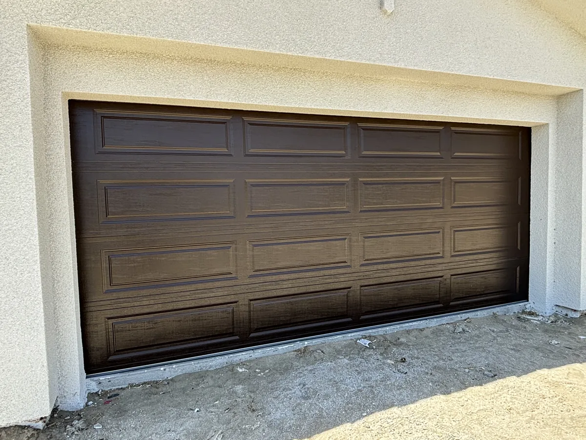 Dark walnut woodgrain raised panel garage door