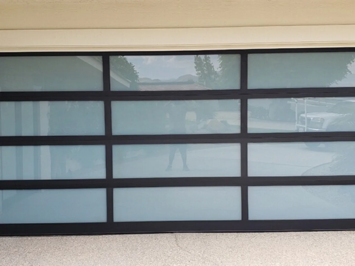 Close view of a frosted glass garage door with black frame dividers