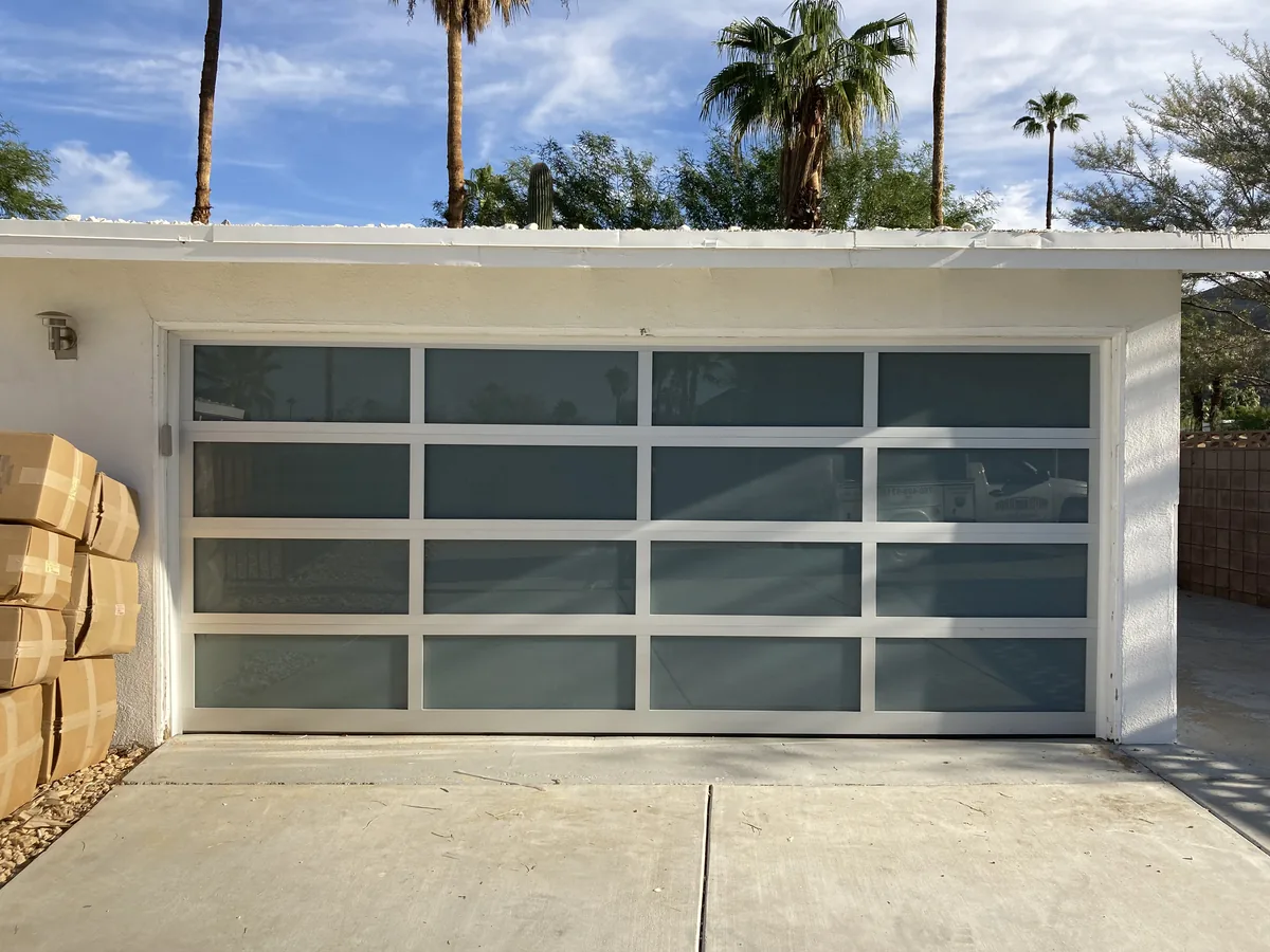 Full view glass garage door with a white aluminum frame installed on a Palm Springs home