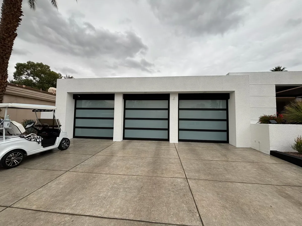 Three full view glass garage doors on a three car garage