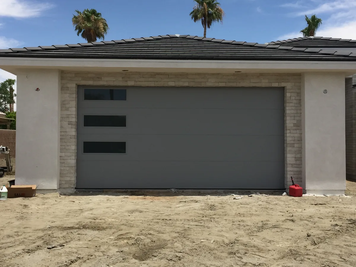Light gray flush garage door with horizontal window inserts
