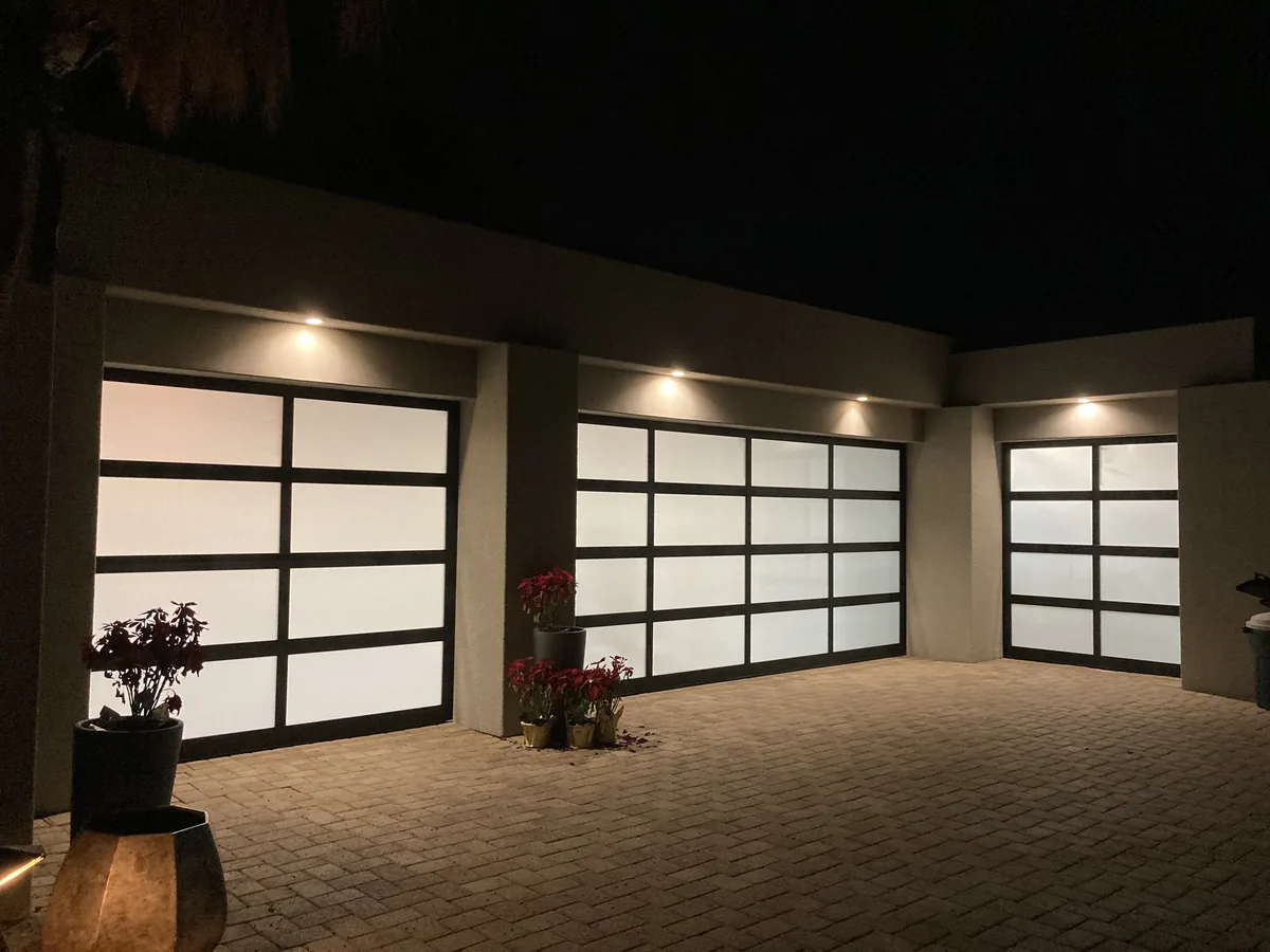 Three full view frosted glass garage doors with dark frames