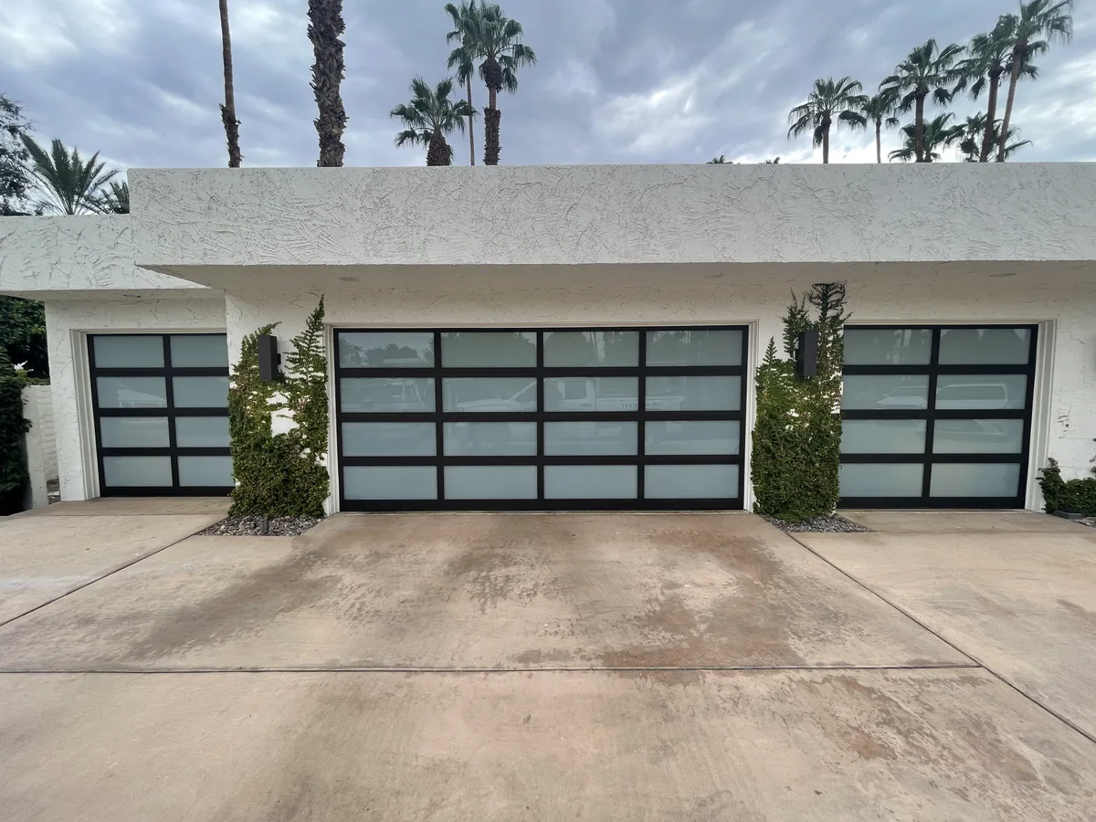 Two full view frosted glass garage doors on a single story home