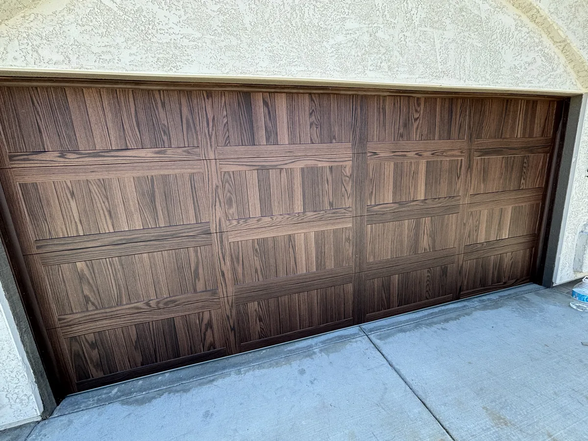 Weathered wood garage door with faded and split panels