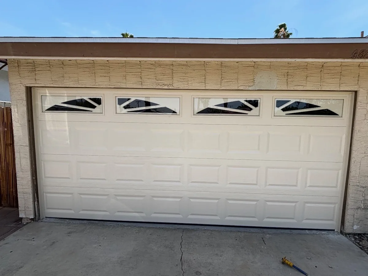 White raised panel garage door with a row of arched window inserts