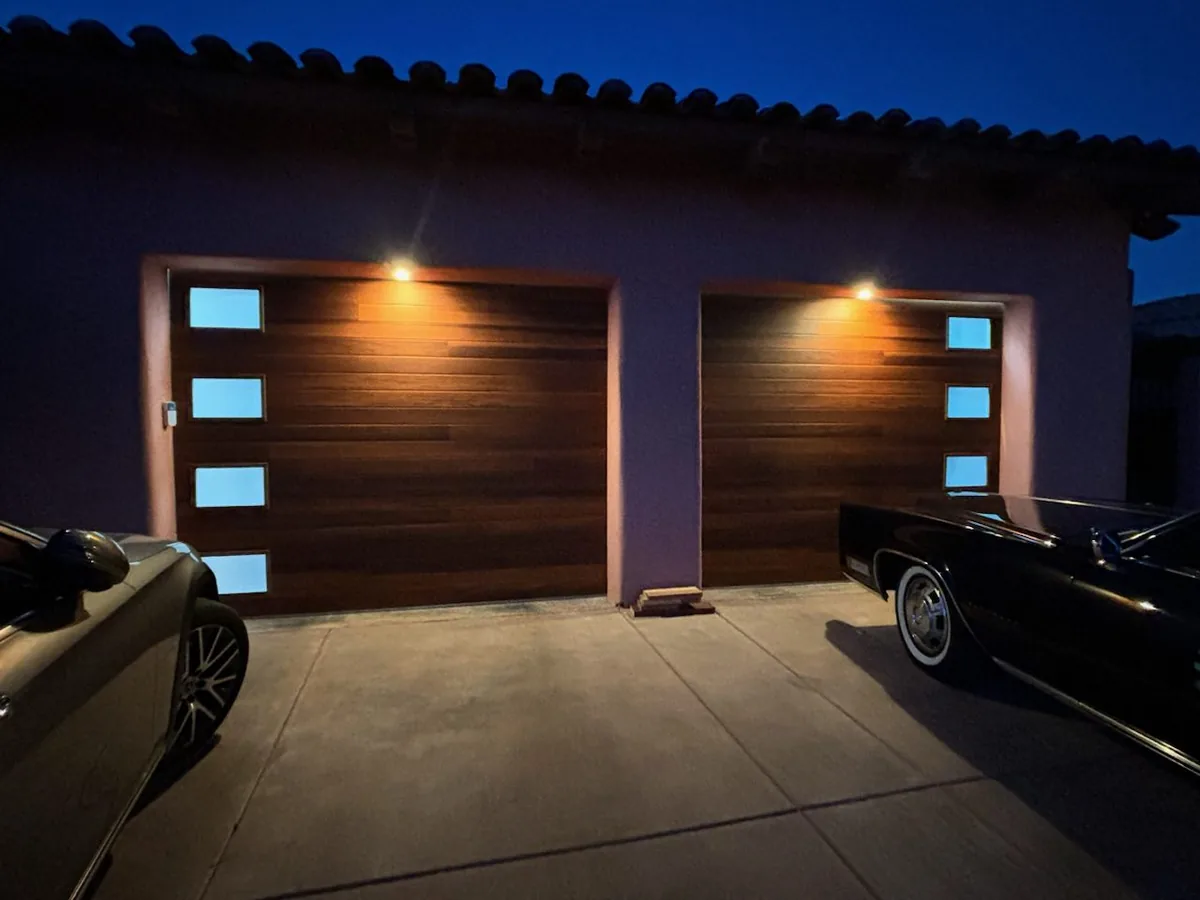 Two wood look garage doors with vertical window slots